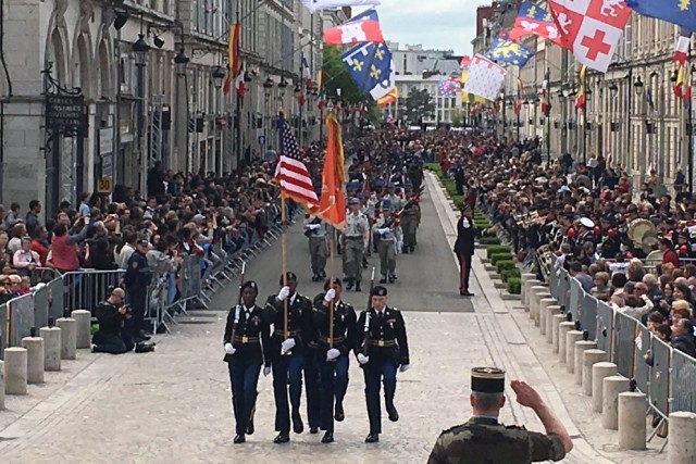 US Army color guard marches in parade marking World War I liberation of Orleans