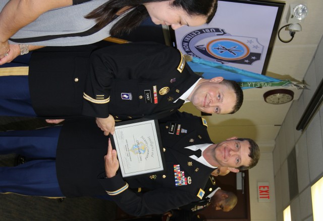 CPT Casey receives graduation certificate from COL Branch
