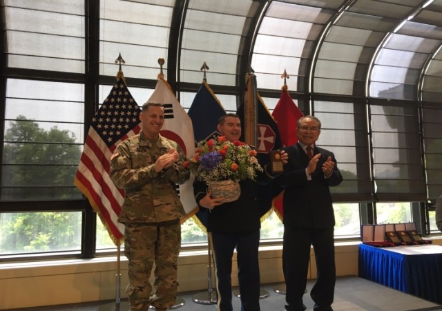 Lt. Gen. Thomas Vandal and Rocky Park congratulate Maj. Scuba on award winning essay