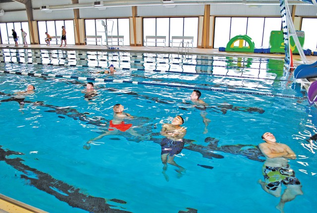 About 50 Fort Riley Soldiers take pretests July 7 before taking lifeguard certification courses at the post's Eyster Pool.