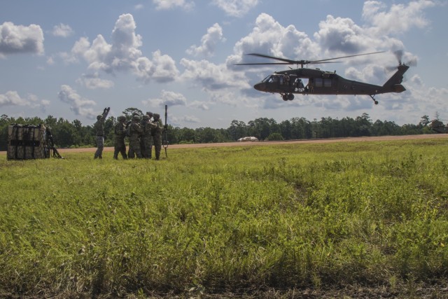 Troops sling load supplies to keep comrades in fight