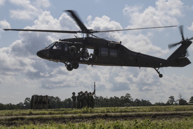 Troops sling load supplies to keep comrades in fight
