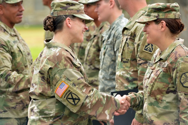 IMCOM CSM Melissa Judkins congratulates IMCOM Soldier of the Year Spc. Lillian Lewis