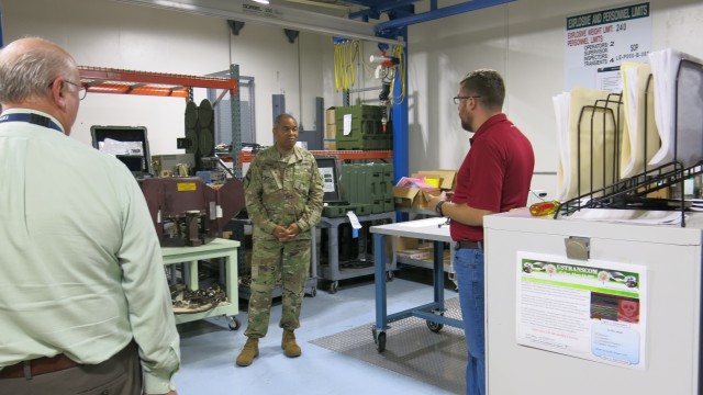 Letterkenny Munitions Center employee, Josh Shaul, provides an overview of Multiple Launch Rocket System Family of Munitions (MFOM) electronics and wiring activities to Lt. Gen. Piggee.
