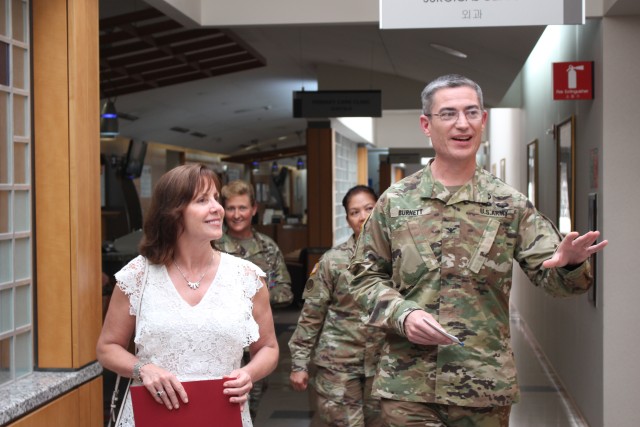Col. Lee Burnett and Command Team give Mrs. Jean Case a tour of the hospital