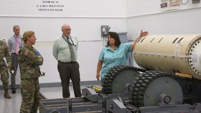 Lisa Michael briefs Col. Heidi Hoyle, Commander of Joint Munitions Command, on Letterkenny Munitions Center's Non-Destructive Testing/X-Ray capabilities while Ed Averill and Keith Byers look on. 