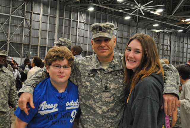 Evan, son; Snyder; and Kaylee, daughter, after returning home from deployment.