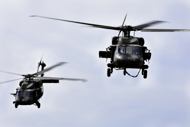 UH-60 Blackhawk helicopters leave the field after inserting troops