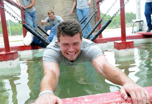 Southwestern football player lays down to be human bridge