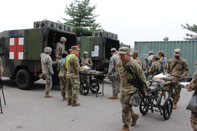 121st CSH Soldiers move the wounded from ambulance trucks