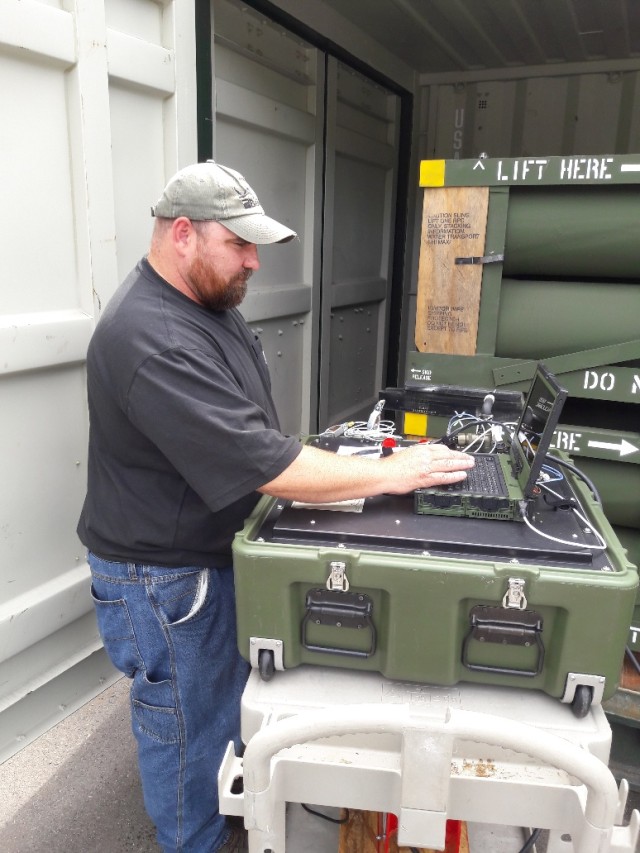 A Letterkenny Munitions Center employee uses a Mission Common Test Device to test Guided Multiple Launch Rocket Systems.
