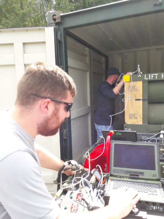 Letterkenny Munitions Center employees use a Mission Common Test Device to test Guided Multiple Launch Rocket Systems.