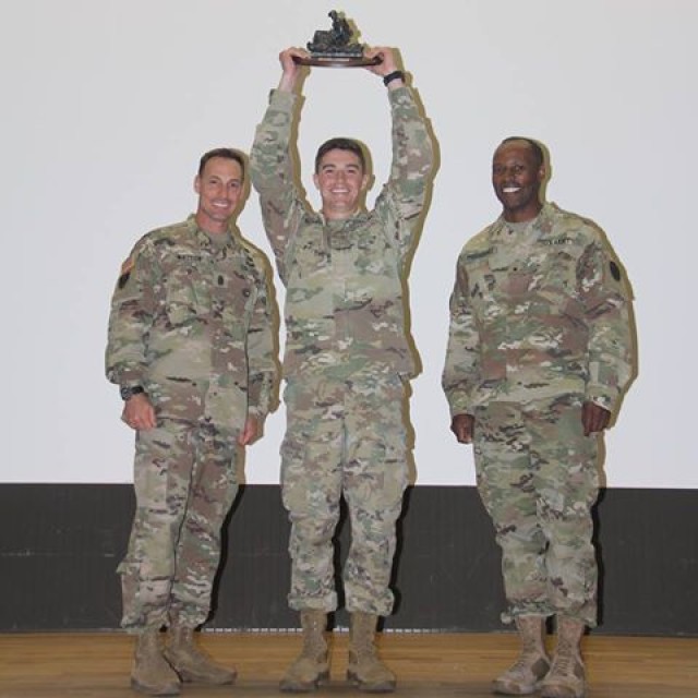 2nd Lt. Adam Schafer holds the 1st place trophy high up