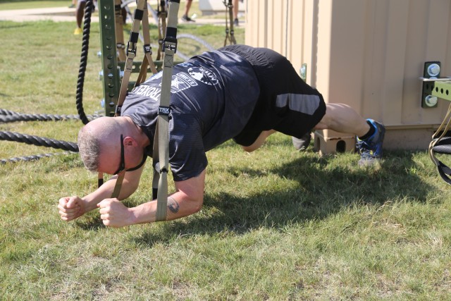 SEAC Troxell demonstrates planking form during PT exercise