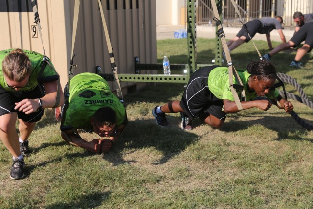 Soldier work together to complete mission during PT exercise