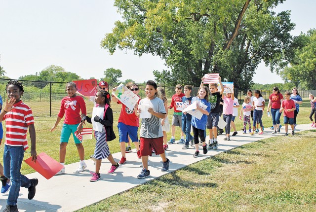 Grade school students at Fort Riley, Kansas, expressed their pride in their parents and country during their annual Freedom Walk Sept. 9.