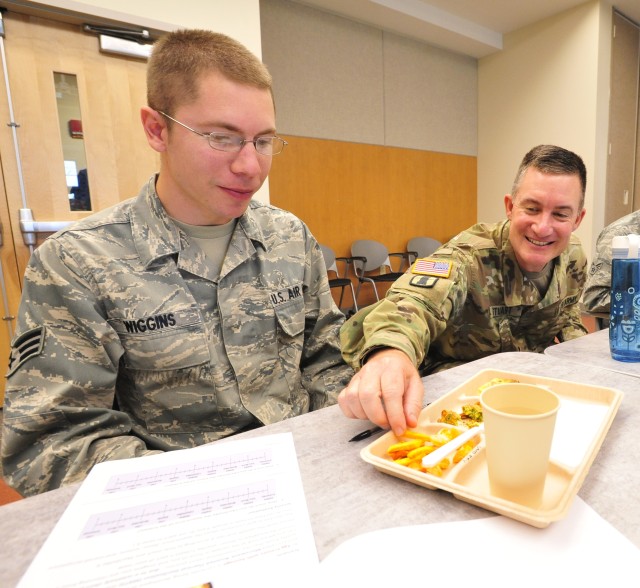 Soldier and Airman enjoy rations