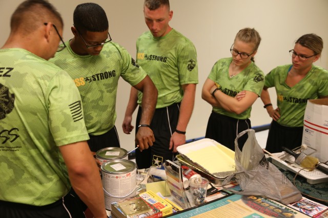 Soldiers study paint colors and prep for top coat