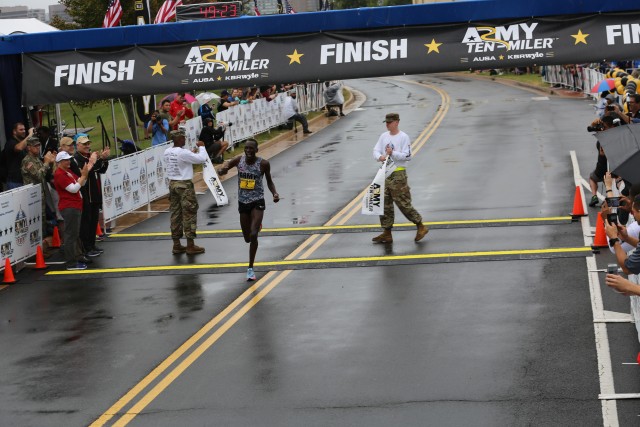 Spc. Haron Lagat crosses the finish line