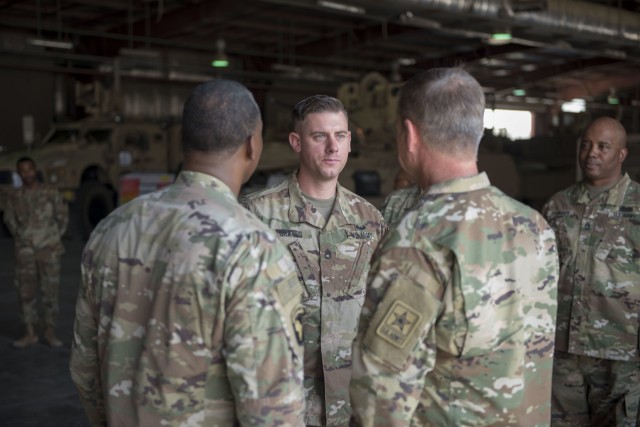 Readiness expert recieves coin from Army Vice Chief