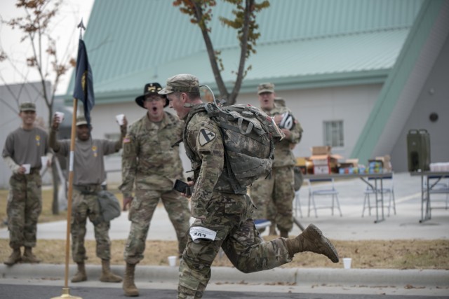 A 2ABCT soldier races to the finish line after 18.6 mile memorial ruck march