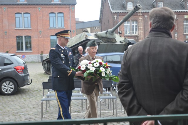 D'Haese and Radoff carry flowers to the 5th Fusiliers Battalion plaque