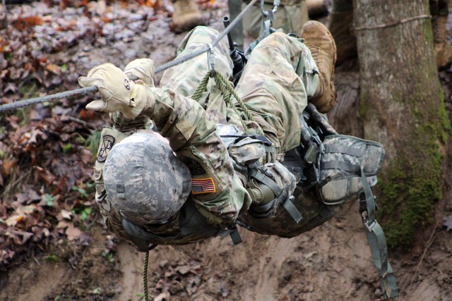 An ROTC cadet crawls on a rope during the 7th Brigade Ranger Challenge.