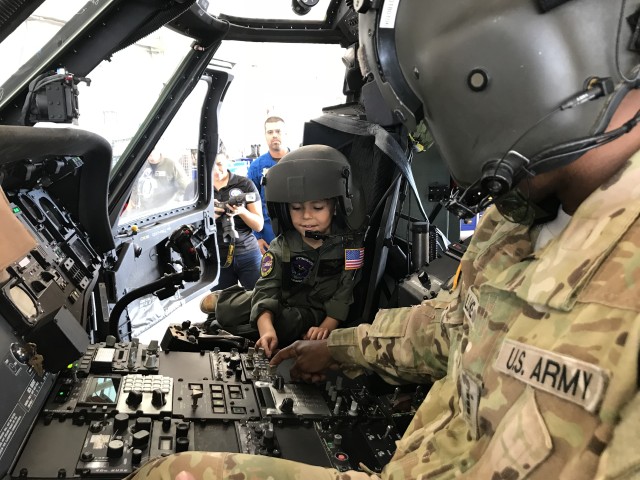 Six-year-old hops into the cockpit of a UH-60 for Pilot for a Day