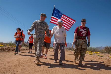 Retired Col. Ben Skardon, 99, a survivor of the Bataan Death March, walks in the annual Bataan Memorial Death March at White Sands Missile Range, N.M., accompanied by two Army medics, March 19, 2017. This was the tenth time Skardon walked in the...