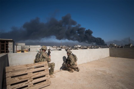 Soldiers deployed use a rooftop as an observation post in Mosul Iraq, March 7, 2017. CJTF-OIR is a global Coalition of more than 60 regional and international nations that have joined together to enable partner forces to defeat ISIS.
