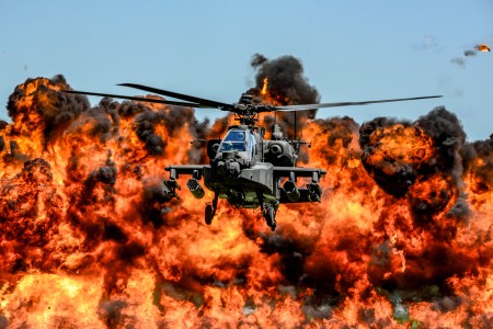 A U.S. Army AH-64D Apache Attack Helicopter flies in front of a wall of fire during the South Carolina National Guard Air and Ground Expo at McEntire Joint National Guard Base, S.C., May 6, 2017.