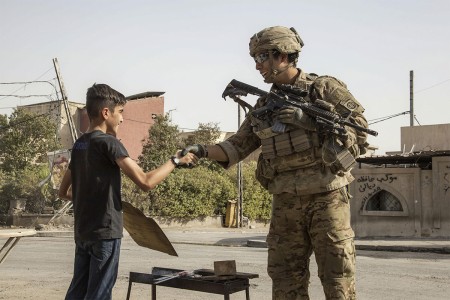 A Soldier shakes the hand of a young boy while patrolling to support Operation Inherent Resolve in Mosul, Iraq, July 4, 2017. The soldier is a paratrooper assigned to the 82nd Airborne Division&#39;s 2nd Brigade Combat Team.