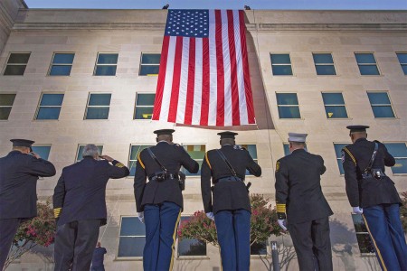 First Responders salute a large American flag as it&#39;s unfurled over the west side of the Pentagon at sunrise in Washington, D.C., Sept. 11, 2017. During the Sept. 11, 2001 attacks, 184 people were killed at the Pentagon.