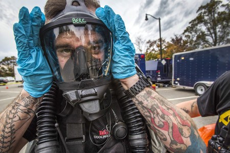 A survey team member of 21st Weapons of Mass Destruction-Civil Support Team, New Jersey National Guard, adjusts his breathing apparatus during an Army North mandated training proficiency evaluation at the Veterans Affairs Medical Center-Lyons,...