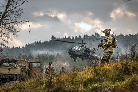 An AH-64 Apache attack helicopter takes off near Soldiers participating in the Allied Spirit VII training exercise, Nov. 18, 2017, at Grafenwoehr, Germany.  Approximately 3,700 service members from 13 nations gathered in southeastern Germany to...