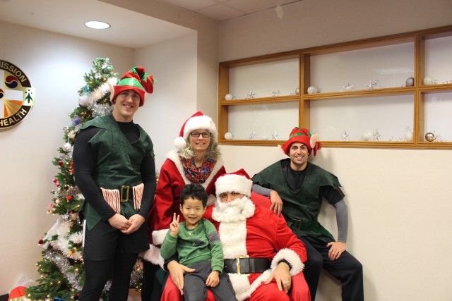 Posing with Santa and his helpers