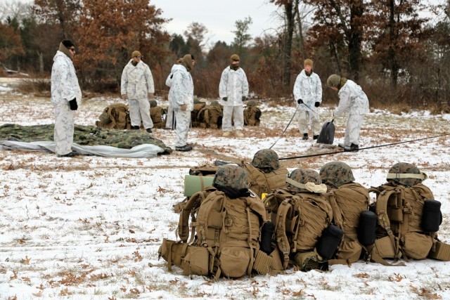 Cold-Weather Operations Course 18-01 students, all Marines, practice tentbuilding at Fort McCoy