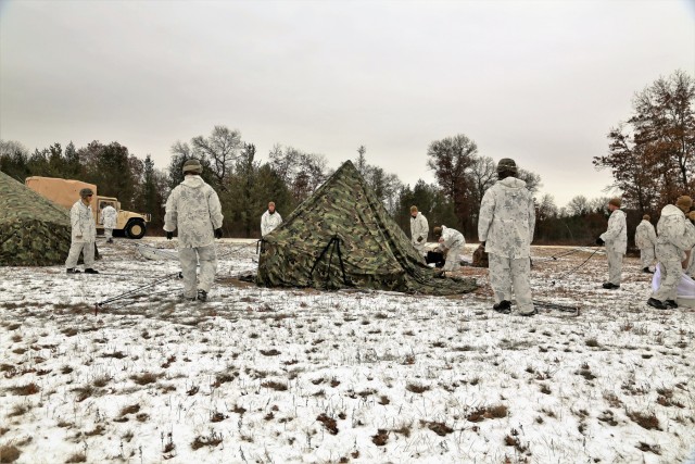 Cold-Weather Operations Course 18-01 students, all Marines, practice tentbuilding at Fort McCoy