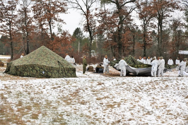 Cold-Weather Operations Course 18-01 students, all Marines, practice tentbuilding at Fort McCoy