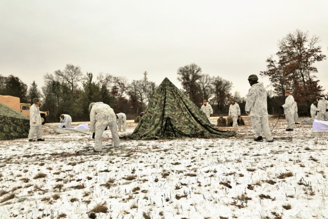 Cold-Weather Operations Course 18-01 students, all Marines, practice tentbuilding at Fort McCoy