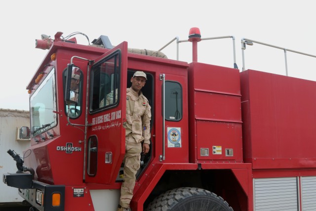 Iraqi Fireman receives help from Coalition Forces