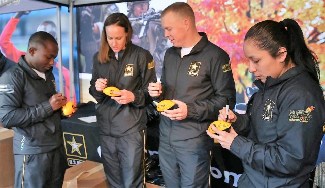 Olympians sign footballs