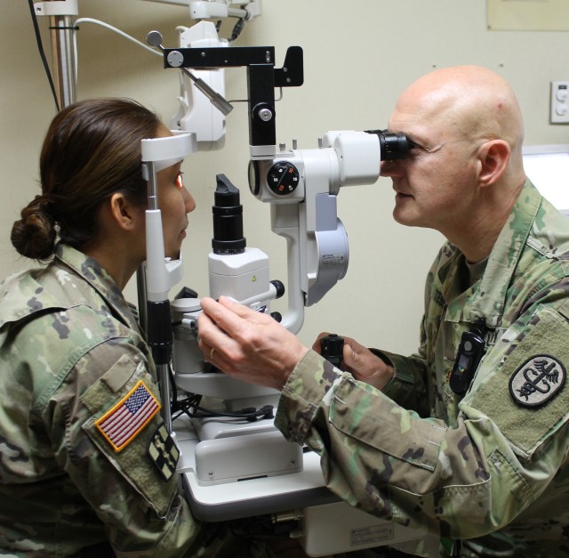 MAJ Charles Tessman, BJACH's Optometrist checks MAJ Camille Betito's vision during an eye exam in the ENT Clinic