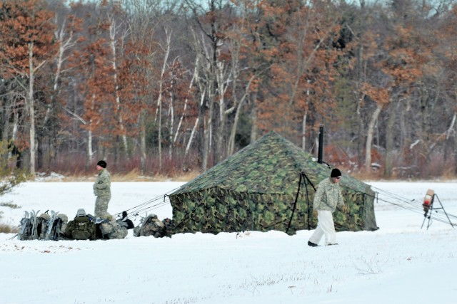 Cold-Weather Operations Course Class 18-02 students build Arctic tents during training at Fort McCoy