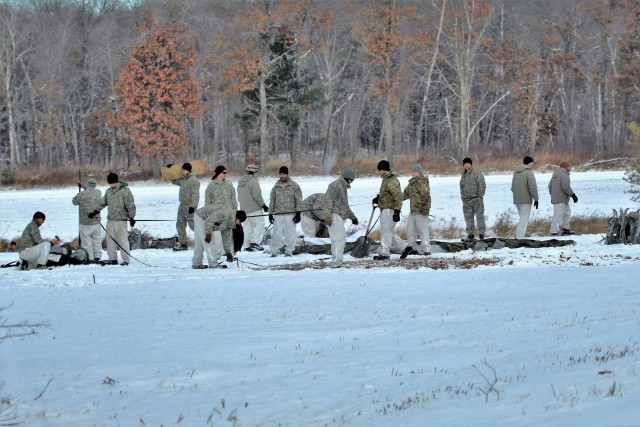 Cold-Weather Operations Course Class 18-02 students build Arctic tents during training at Fort McCoy
