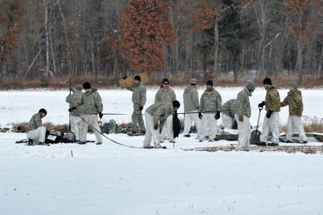 Cold-Weather Operations Course Class 18-02 students build Arctic tents during training at Fort McCoy