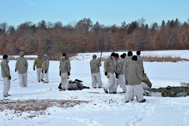 Cold-Weather Operations Course Class 18-02 students build Arctic tents during training at Fort McCoy