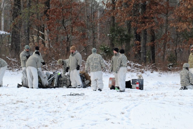 Cold-Weather Operations Course Class 18-02 students build Arctic tents during training at Fort McCoy
