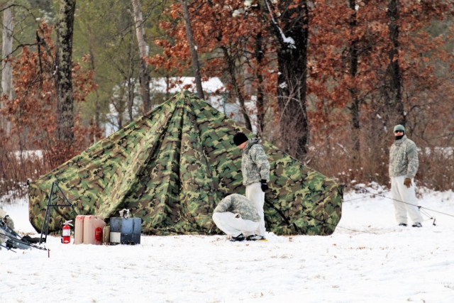 Cold-Weather Operations Course Class 18-02 students build Arctic tents during training at Fort McCoy