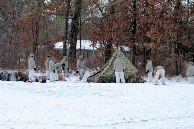 Cold-Weather Operations Course Class 18-02 students build Arctic tents during training at Fort McCoy